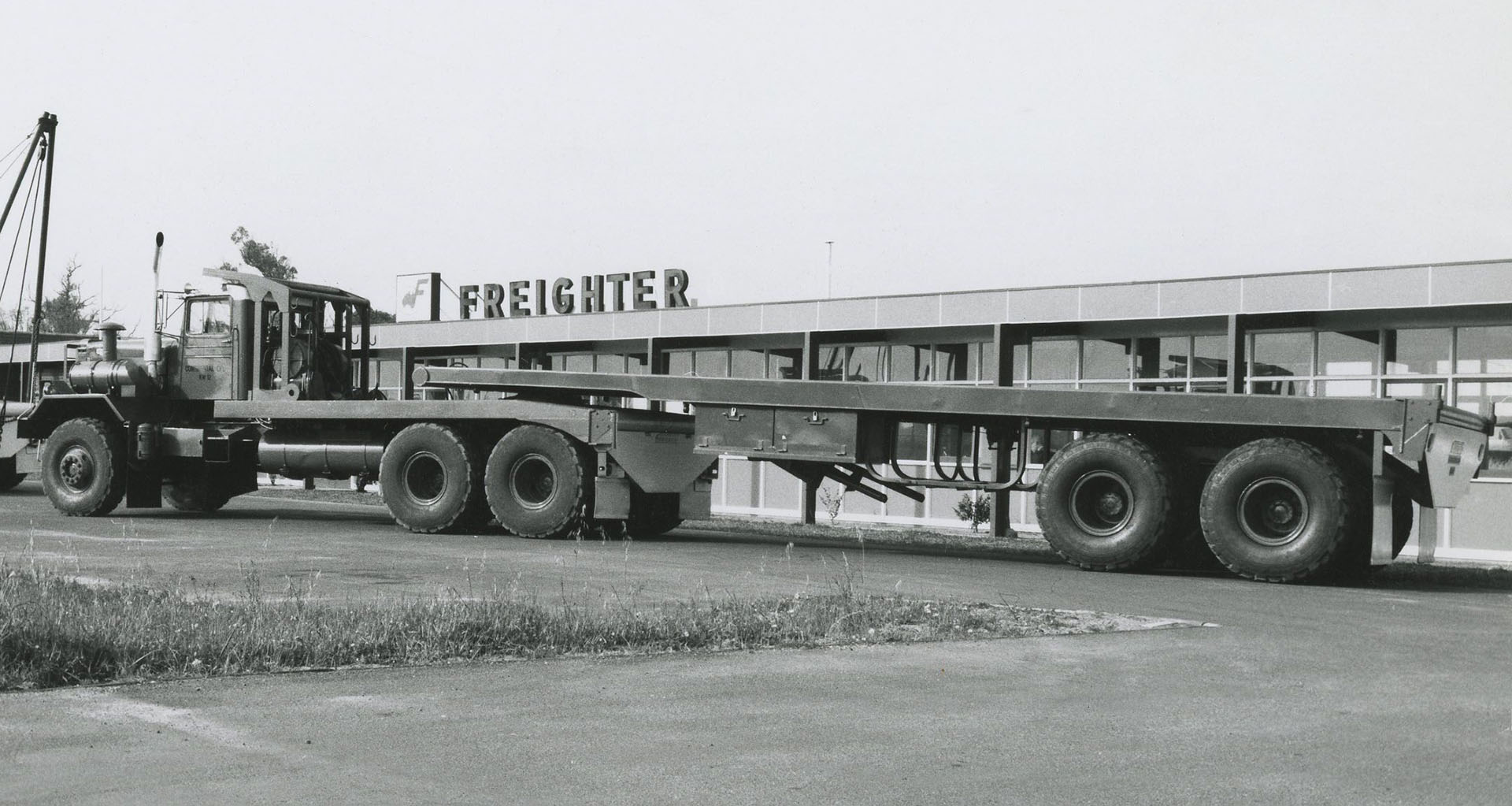 Pictured in front of the Freighter offices, this Tandem axle flat top Freighter trailer is ready for a customer delivery. Photo circa 1960s.