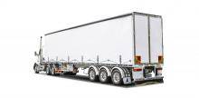 Freighter Mark II curtain sided trailer with fewer buckles shown on truck driving on white background