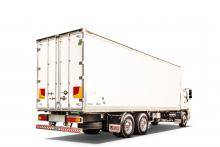 Peki distribution trailer shown on truck driving on a white background